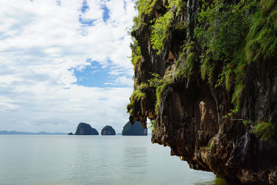 Panoramic view of rock formation in sea against sky