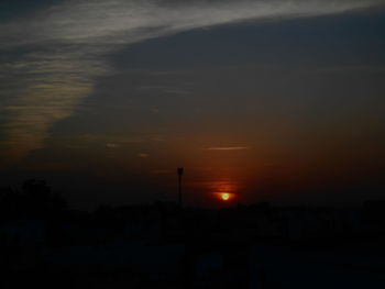 Silhouette of trees against sky at sunset