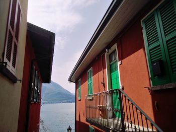 Low angle view of buildings by sea against sky