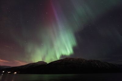 Scenic view of mountains against sky at night