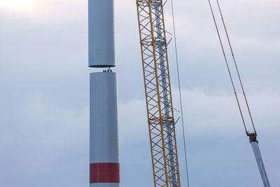 Low angle view of electricity pylon against sky