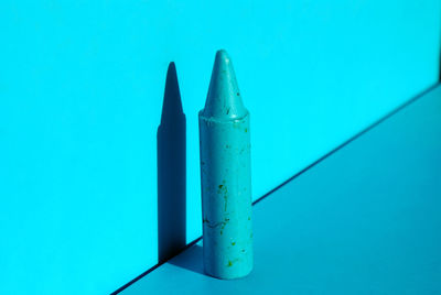 Close-up of pencils against blue wall