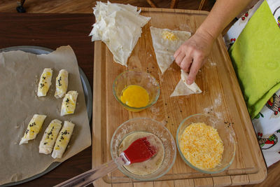High angle view of man preparing food on cutting board