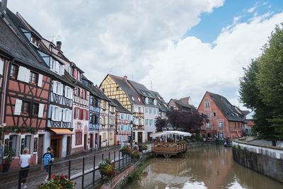 View of buildings in city against cloudy sky