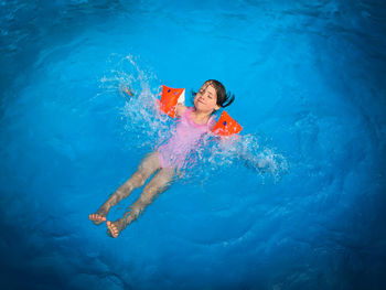 High angle view of woman swimming in pool