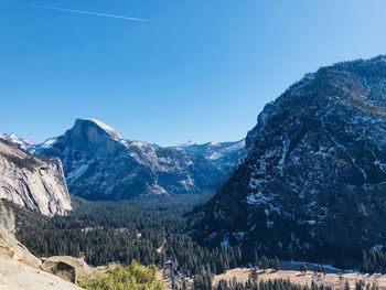 Scenic view of snowcapped mountains against clear blue sky