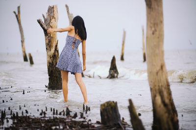 Rear view of woman walking on beach