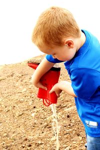 Portrait of boy playing with ball