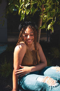 Portrait of a smiling young woman sitting outdoors