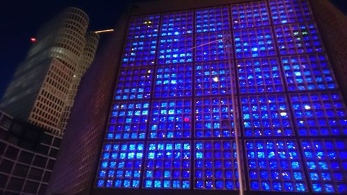 Low angle view of illuminated tower at night