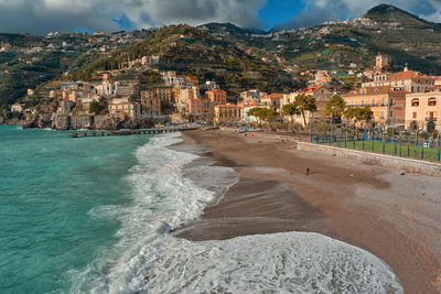 Scenic view of beach by buildings in city