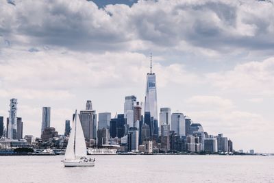 View of skyscrapers against cloudy sky