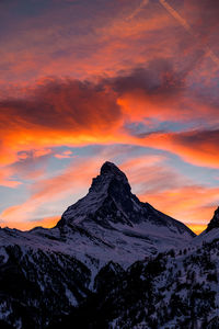 Scenic view of snowcapped mountains against sky during sunset