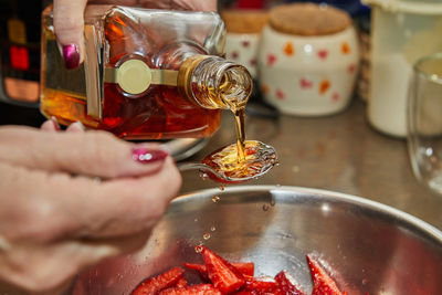 Cropped hand of person preparing food on table