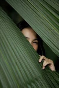 Portrait of a woman hiding outdoors