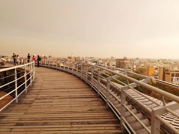 Bridge over city against sky