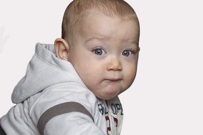 Portrait of cute baby against white background