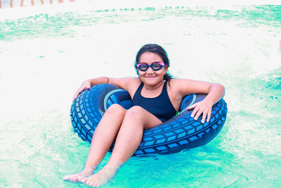 Portrait of smiling woman in inflatable ring