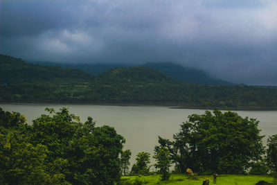 Scenic view of lake and mountains against sky