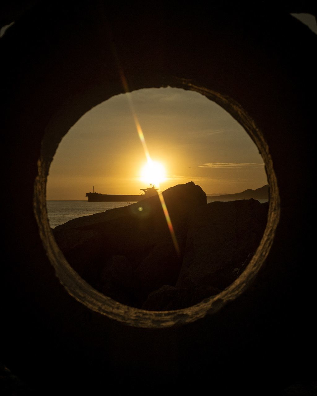 CLOSE-UP OF SEA AGAINST SKY AT SUNSET