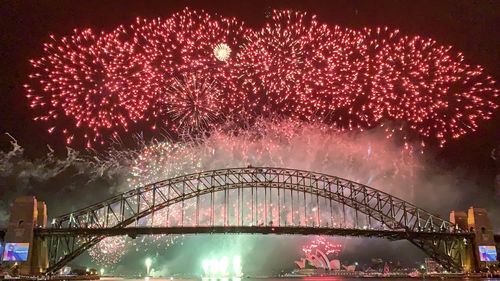 Firework display over illuminated city at night