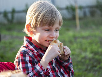 Portrait of boy eating food