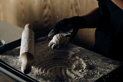 Cropped hand of man working on wood