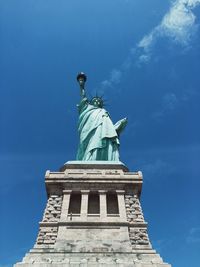 Low angle view of statue against blue sky