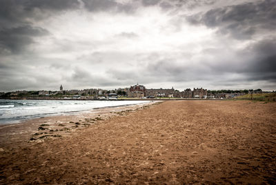 View of beach against cloudy sky