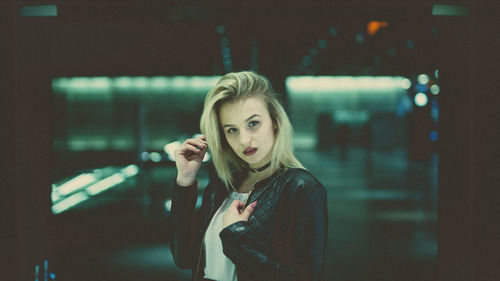 Portrait of young woman at railroad station