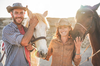 Portrait of smiling young man with horse