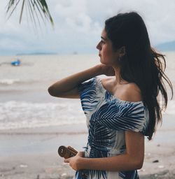 Young woman looking at sea shore