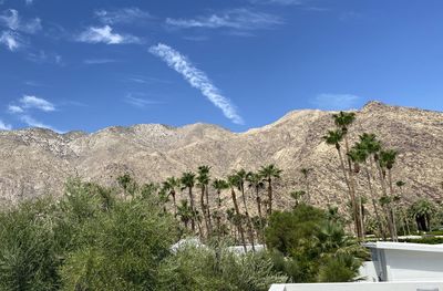 Scenic view of land and mountains against sky