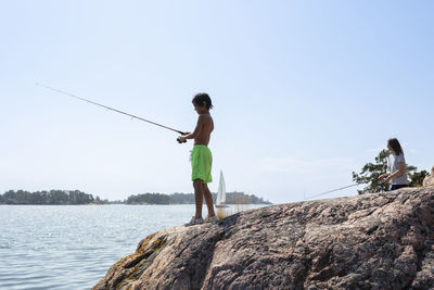 Boy fishing at lake