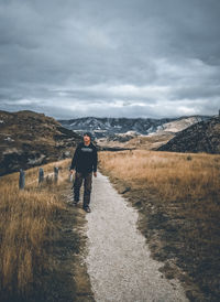 Man on field against sky