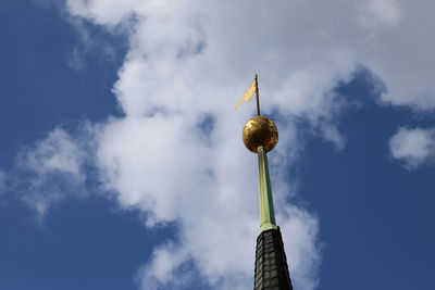 Low angle view of tower against cloudy sky