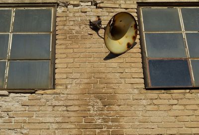 Low angle view of lamp on wall of building