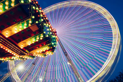 Blurred motion of illuminated ferries wheel at night