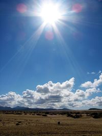 Scenic view of beach against blue sky