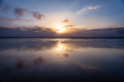 Scenic view of beach against sky during sunset