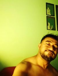 Portrait of young man against wall