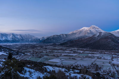 Scenic view of snow covered mountains against sky