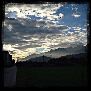 Scenic view of mountains against cloudy sky