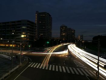 Light trails on road in city at night