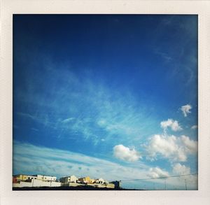 Buildings against cloudy sky