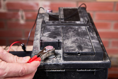 Cropped hand of man welding metal