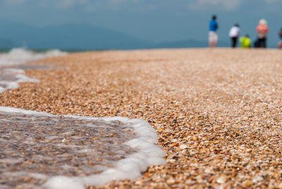 Waves reaching on shore at beach