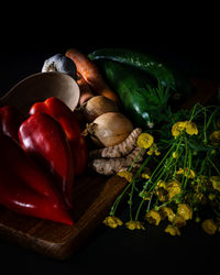 Close-up of chili peppers on table against black background