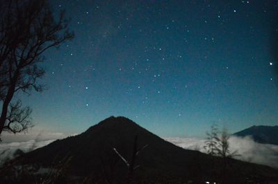 Low angle view of silhouette mountain against sky at night