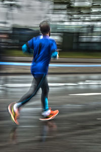 Blurred motion of people walking on road